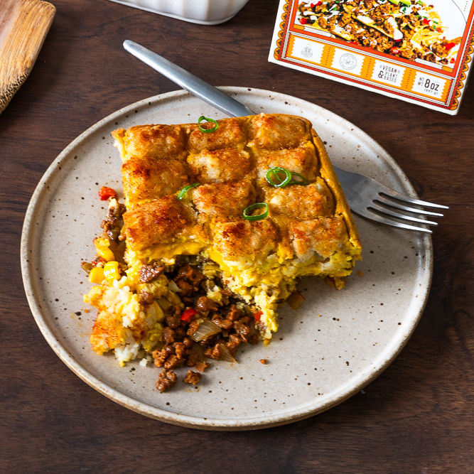 Vegan breakfast bake with Chorizo Seitan and tater tots on a white plate